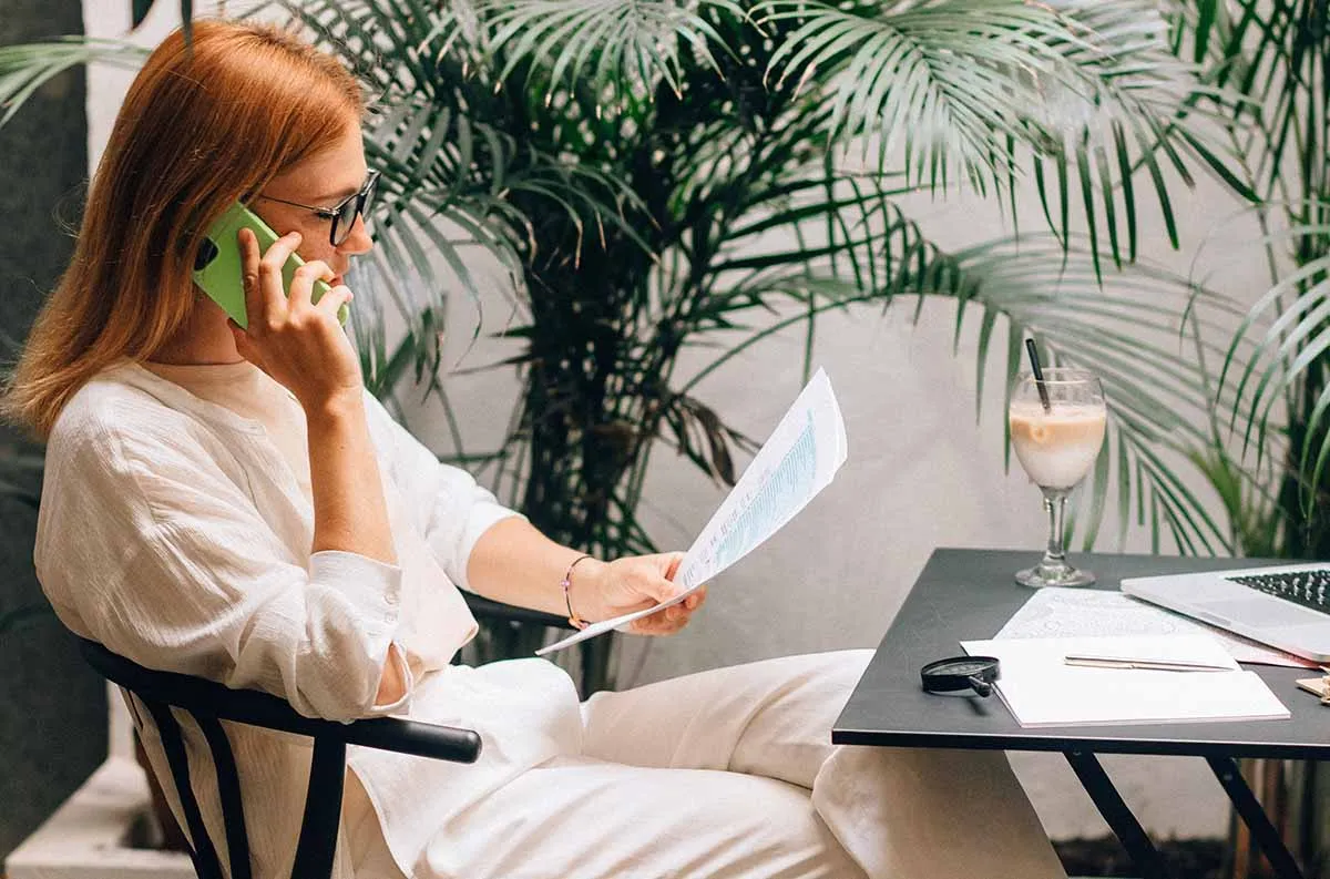 Woman on phone looking for strategies to resolve IRS tax debt