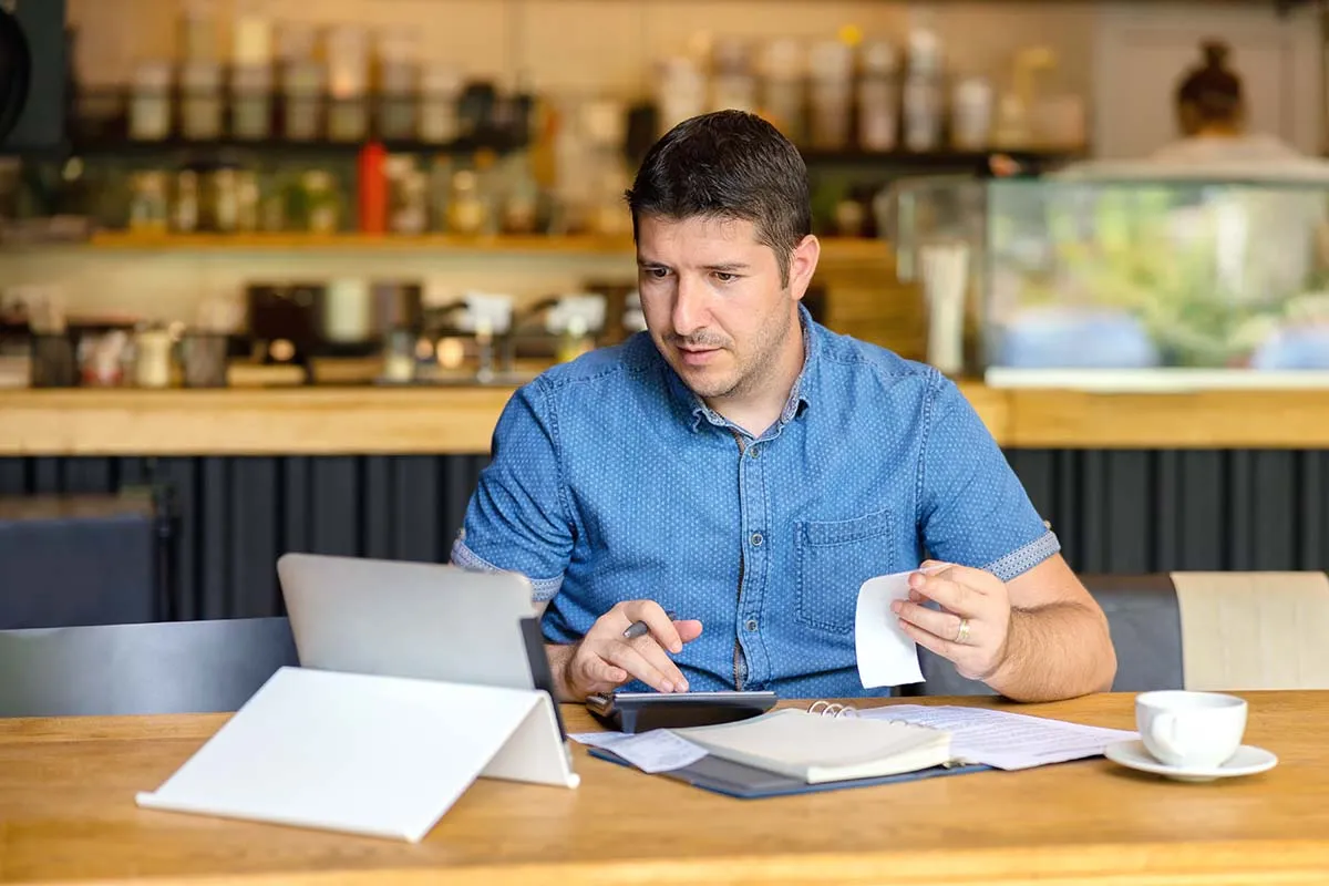 Restaurant Owner Looking over Receipts