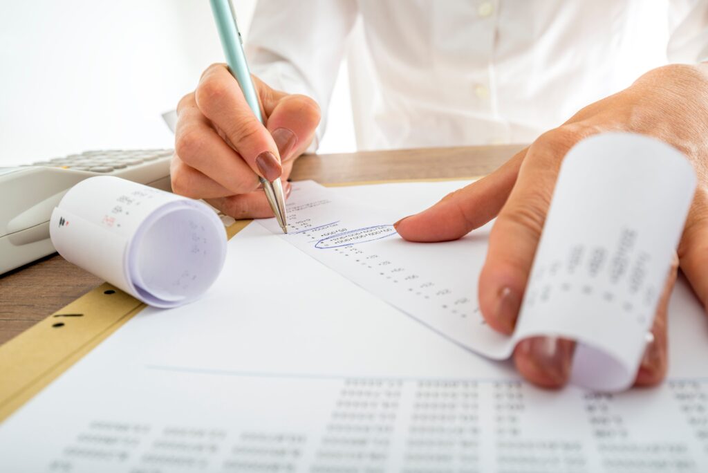 An IRS audit attorney looking over a client's receipts and earnings.